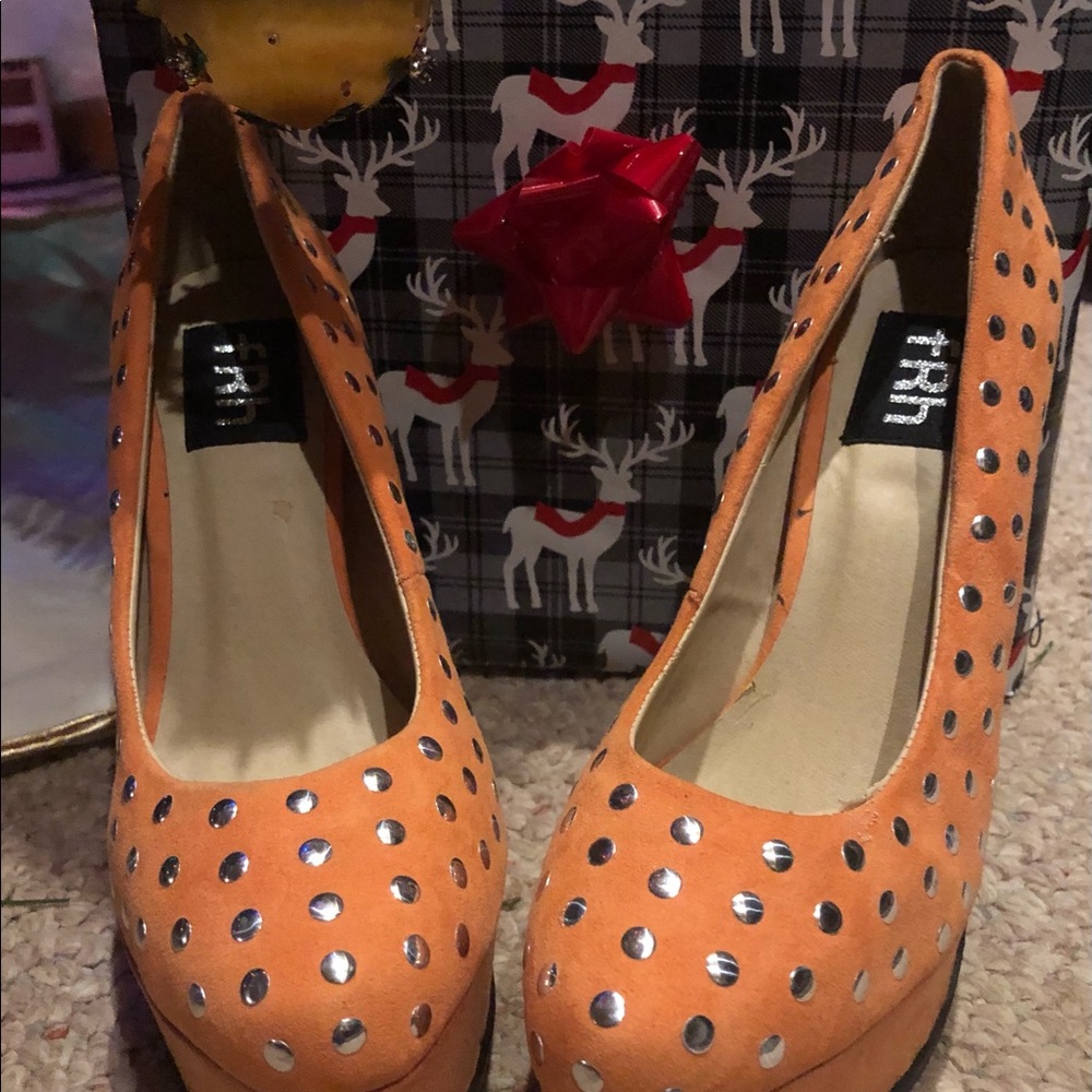 Brand is FRH. Orange with silver studs. Never worn